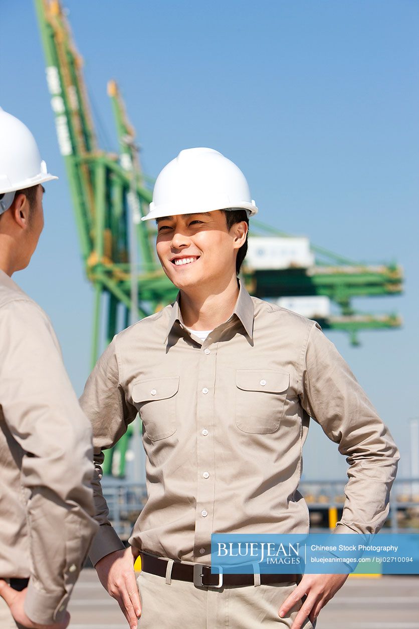 Male Chinese Shipping Industry Workers Talking High Res Stock Photo For