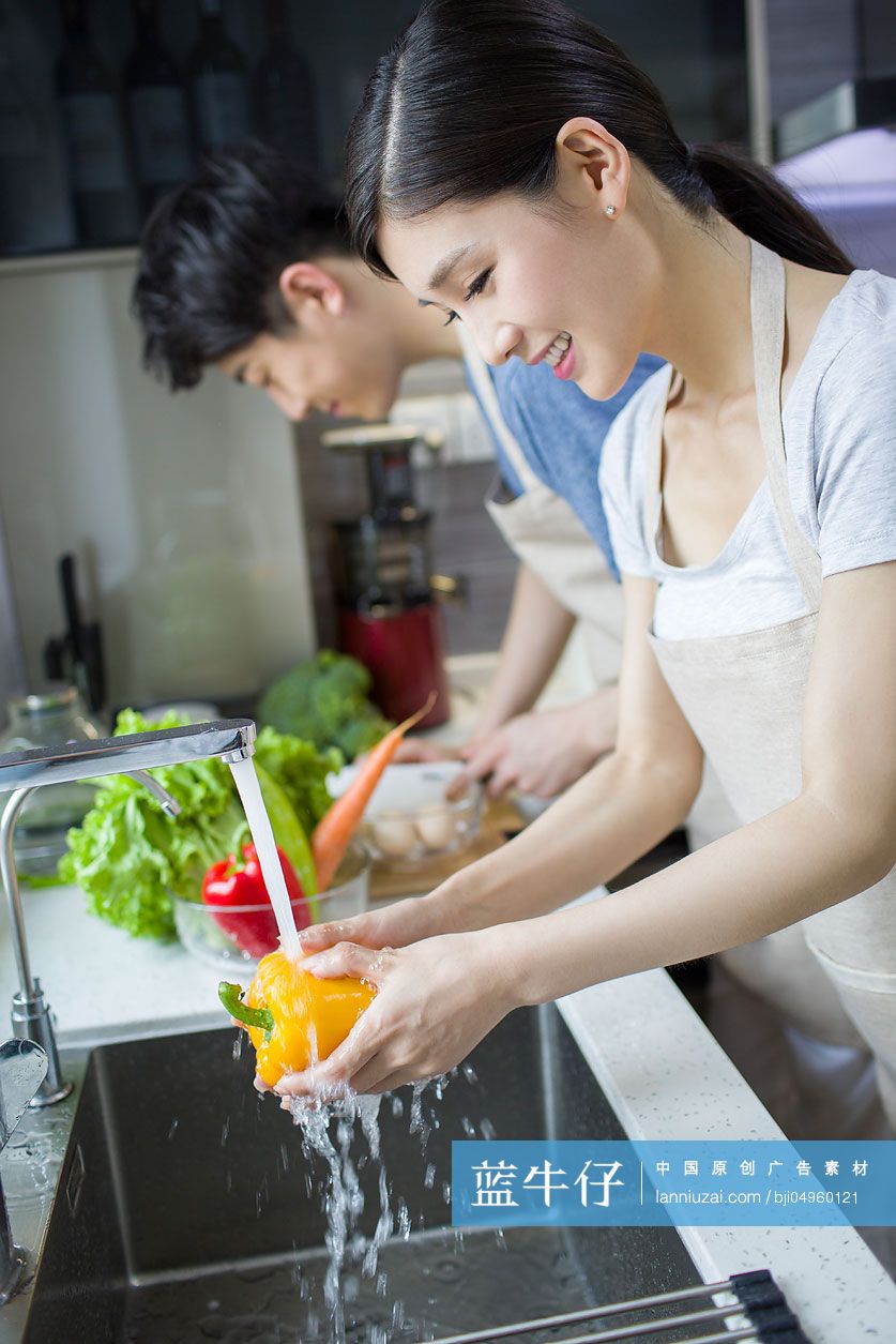 快乐的年轻夫妇在厨房做饭