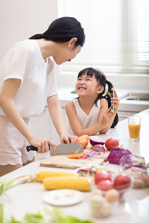 快乐小女孩和妈妈在厨房做饭