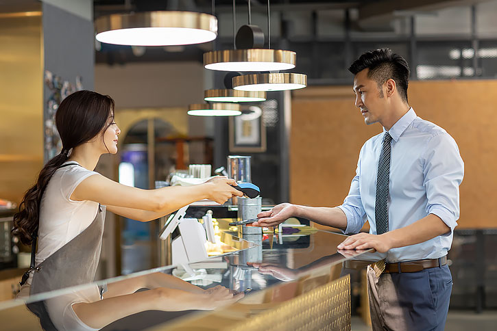 商务男士在咖啡馆用手机结账