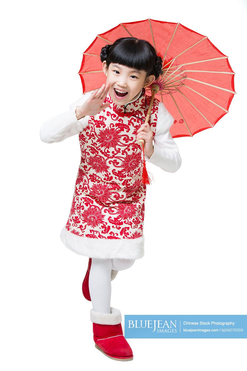 Happy Chinese girl holding a paper umbrella shouting