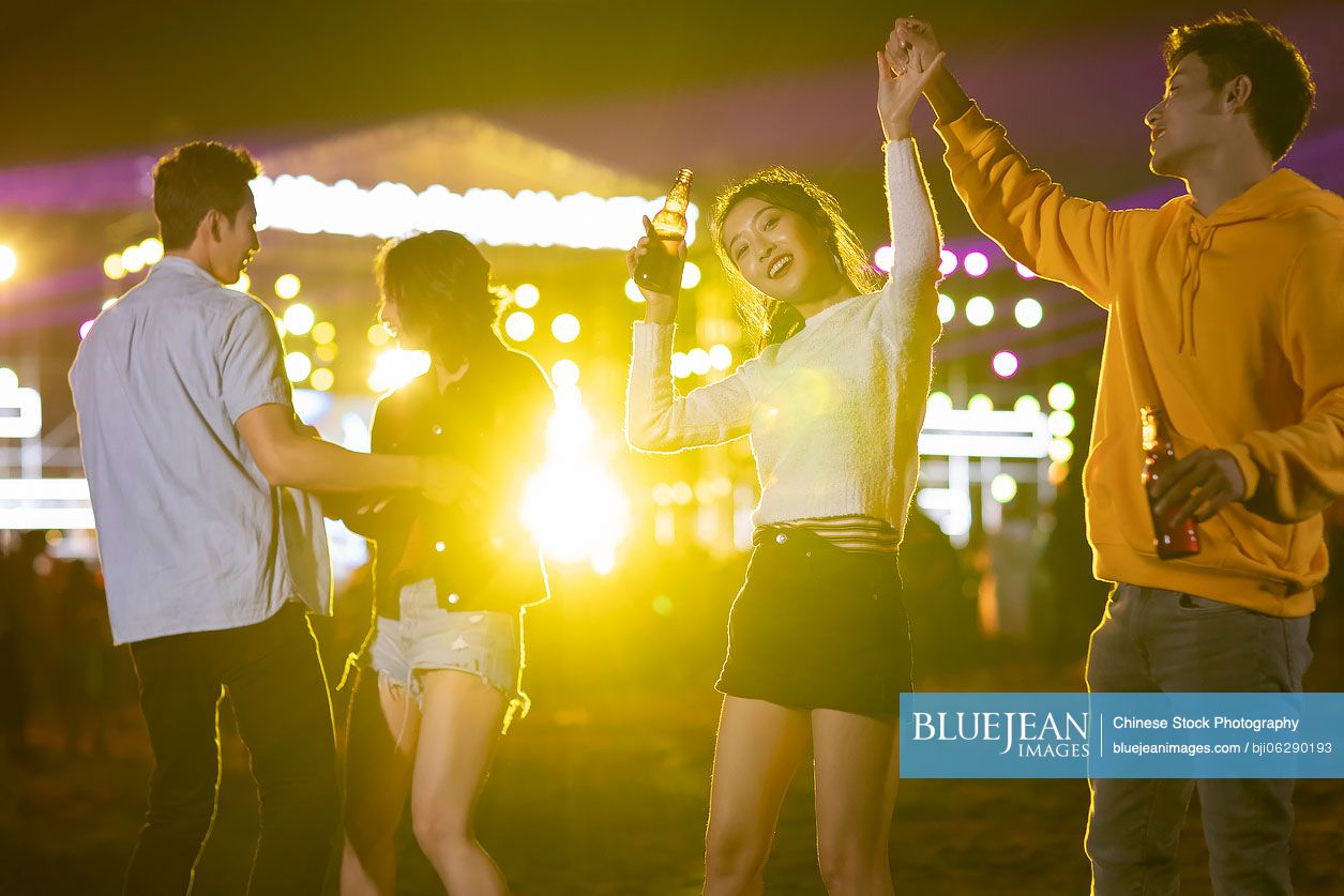 Happy young Chinese friends at music festival