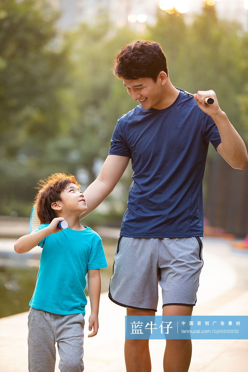 开心的父子俩来公园打羽毛球