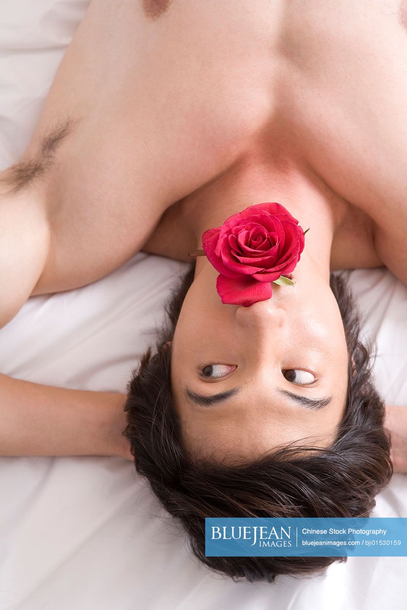 Naked Chinese man on bed with rose-High-res stock photo for download