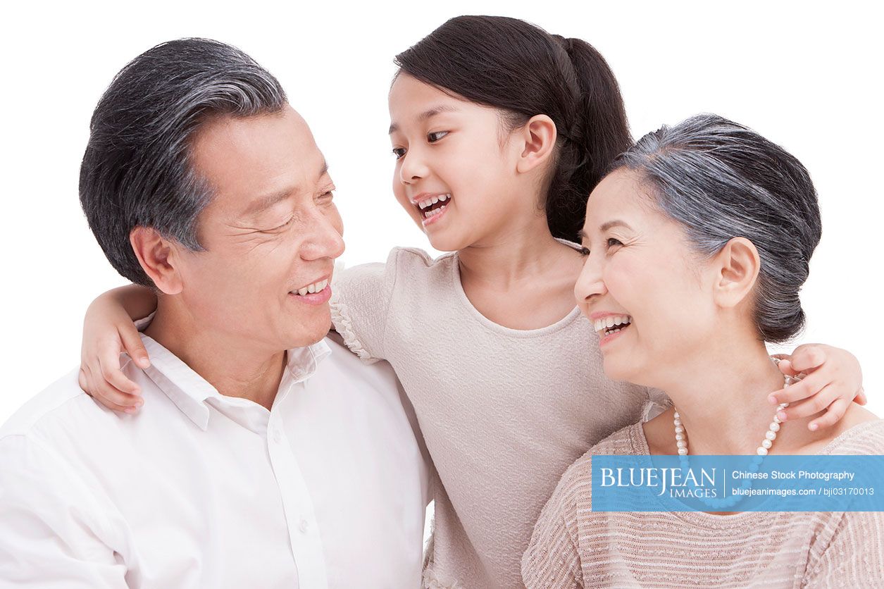 Cheerful Chinese granddaughter with grandparents