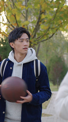 Happy Chinese college boy holding basketball,HD