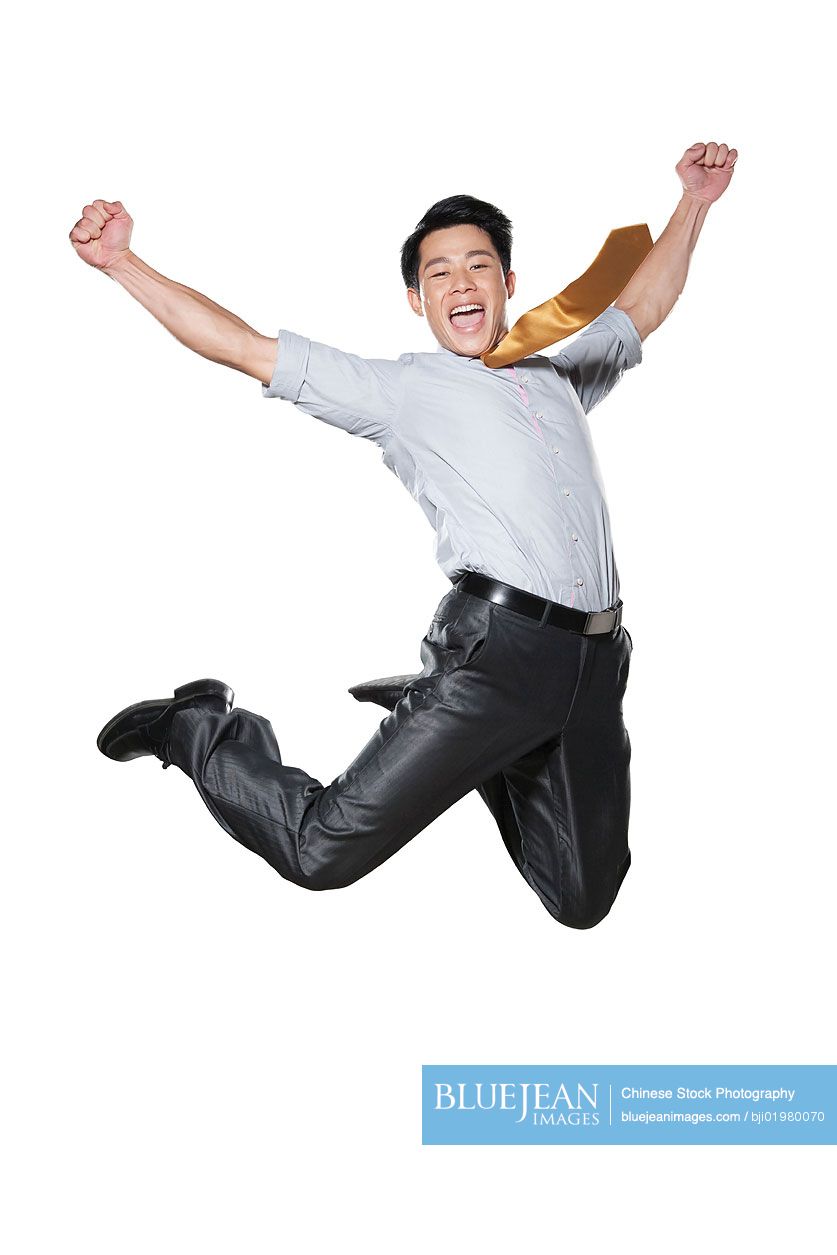 Chinese businessman jumping in the air in celebration