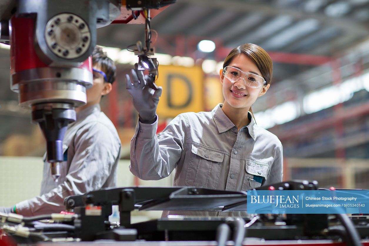 Young Chinese engineers working in the factory