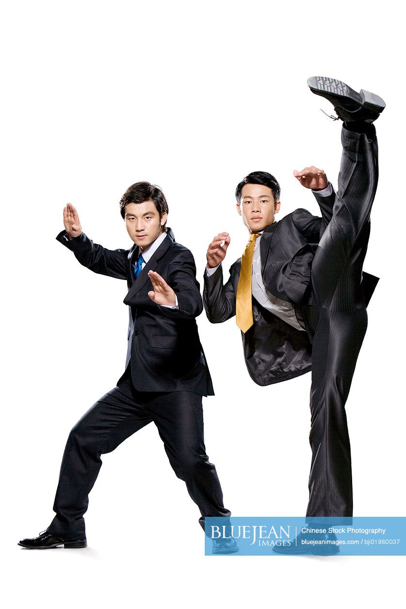 Two Chinese businessmen fighting on white background