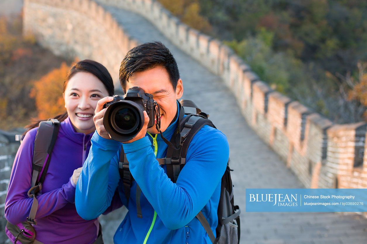 Young Chinese couple photographing on Great Wall