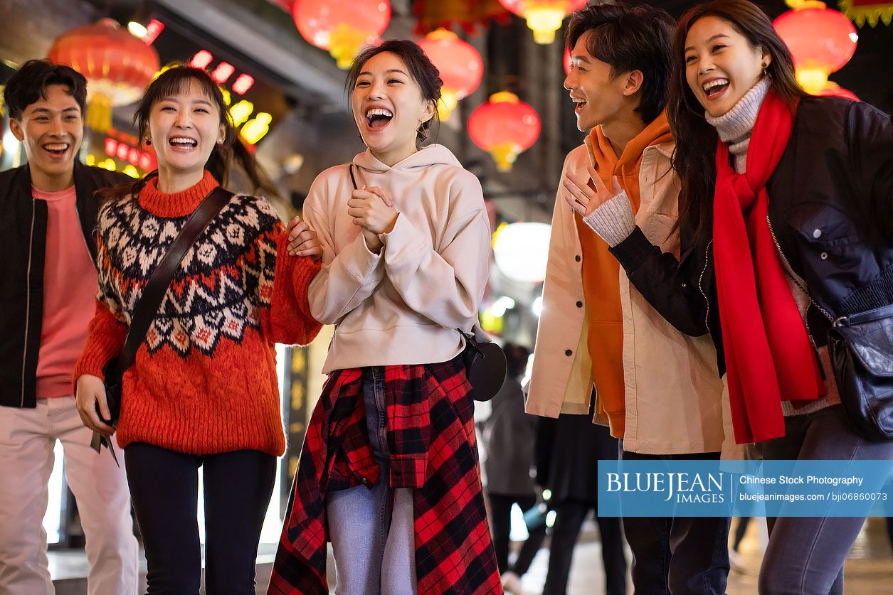 Happy young Chinese friends celebrating Chinese new year