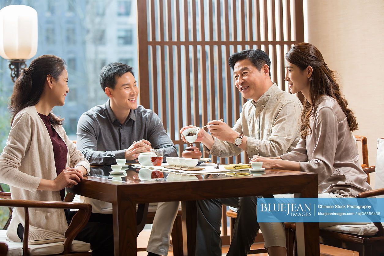 Chinese friends drinking tea together