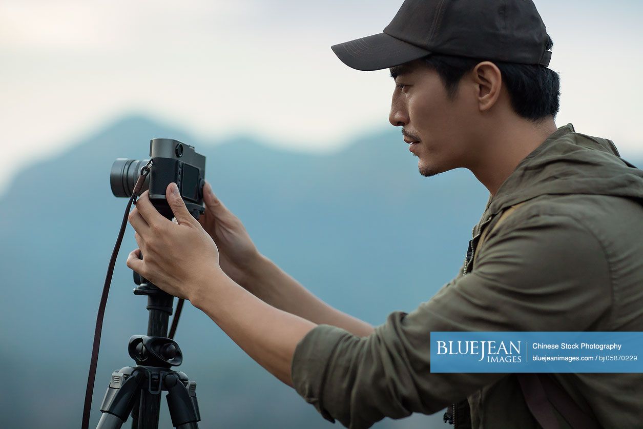 Chinese photographer taking photos outdoors