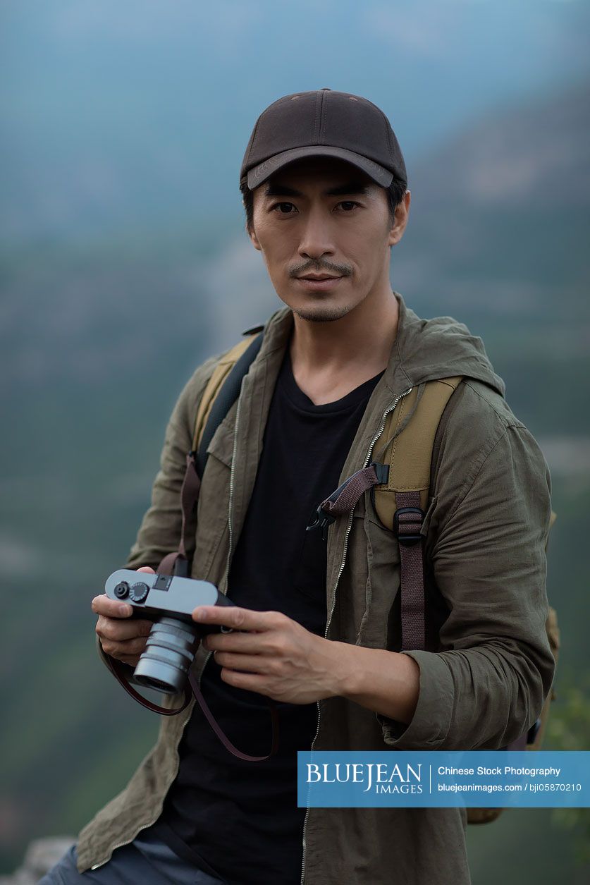 Chinese photographer taking photos outdoors