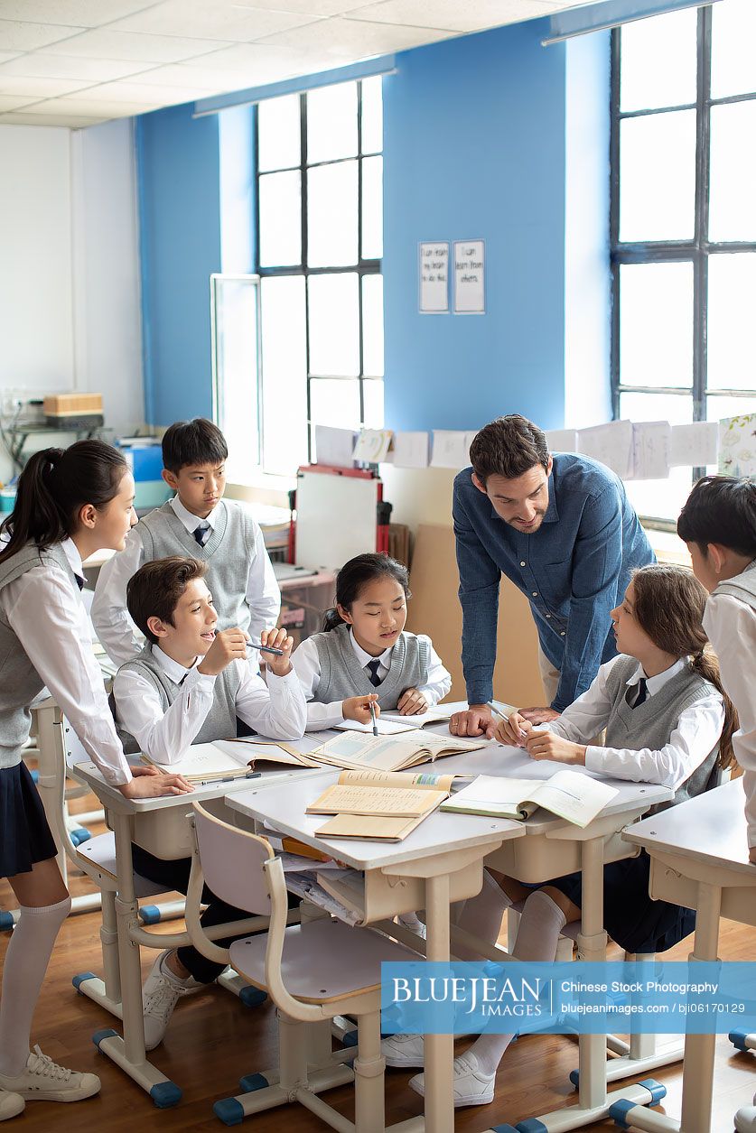 Teacher talking with students in classroom