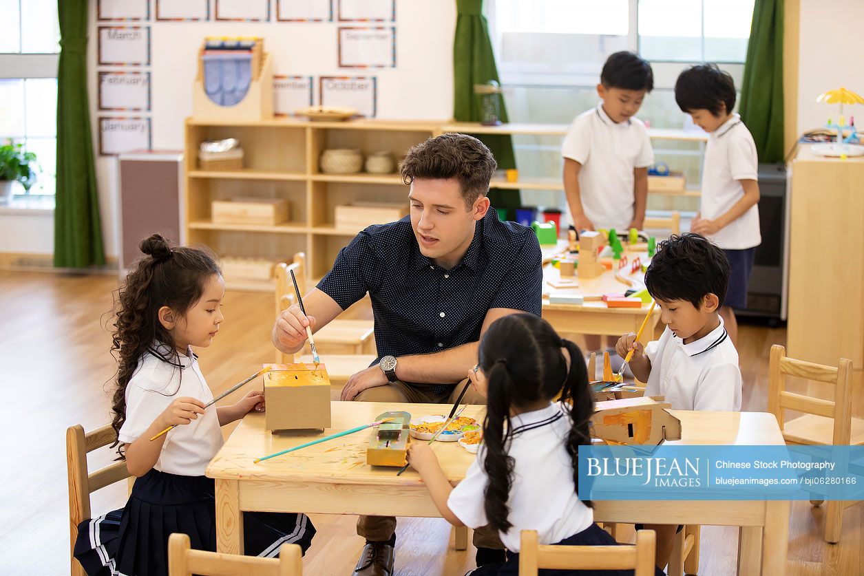 Foreign teacher teaching art class in classroom