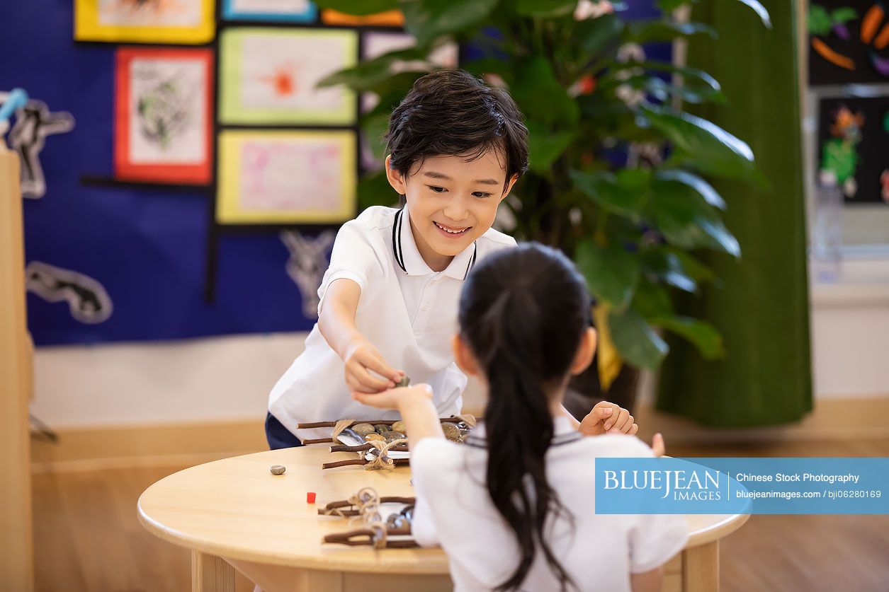 Chinese children having art class in classroom