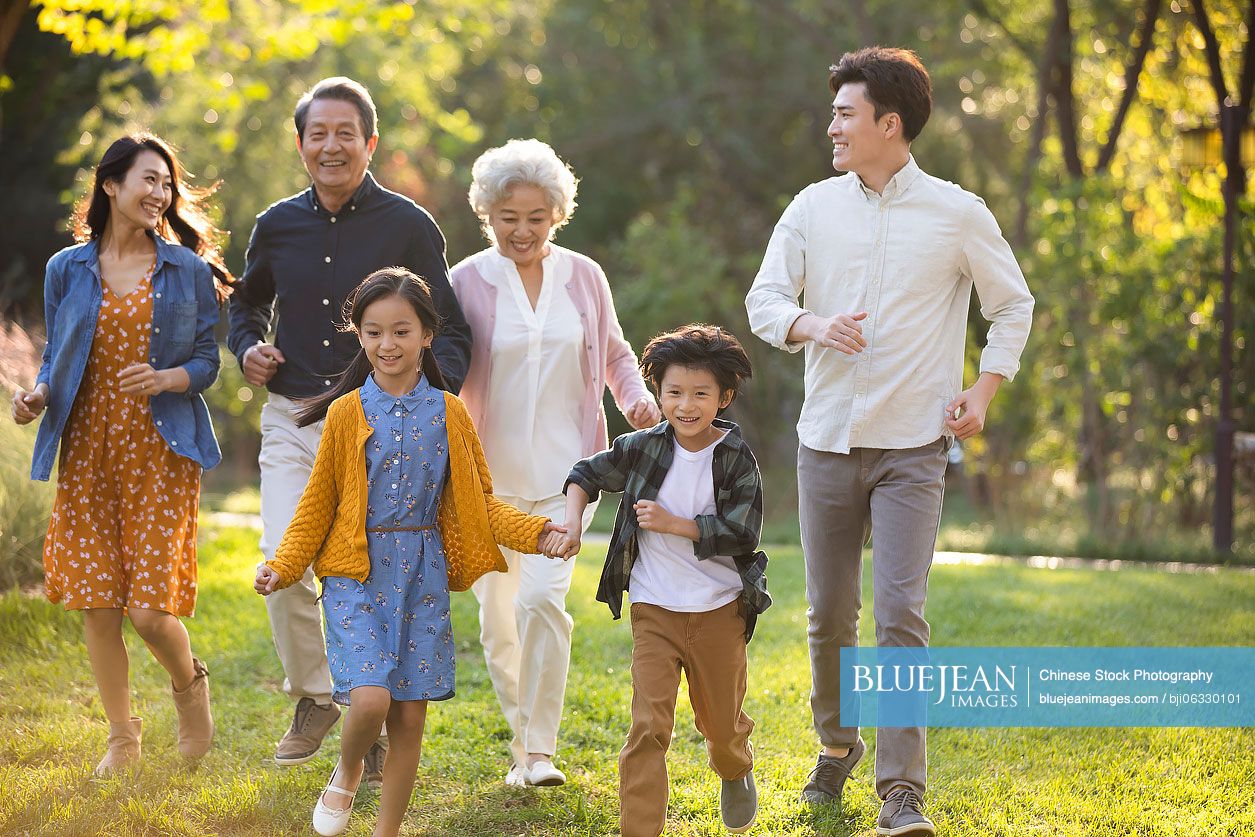 Happy Chinese family having fun in park