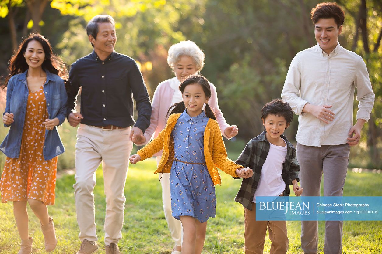 Happy Chinese family having fun in park