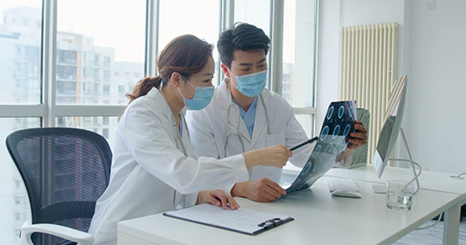 Young Chinese doctors discussing X-ray image,4K