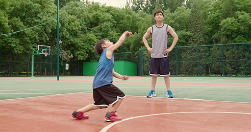 Chinese father and son playing basketball in park,4K