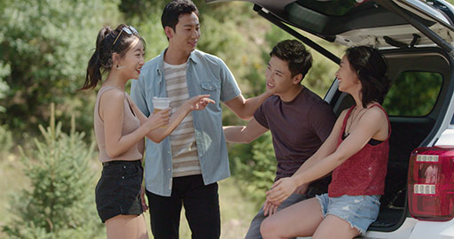 Happy young Chinese friends enjoying road trip,4K