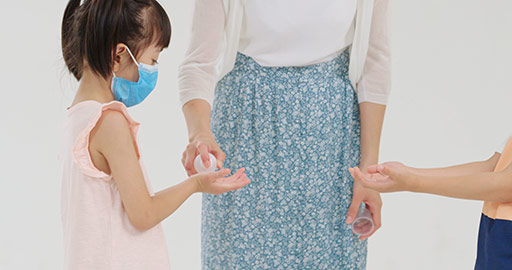 Chinese Children using hand sanitizer with mother's help,4K