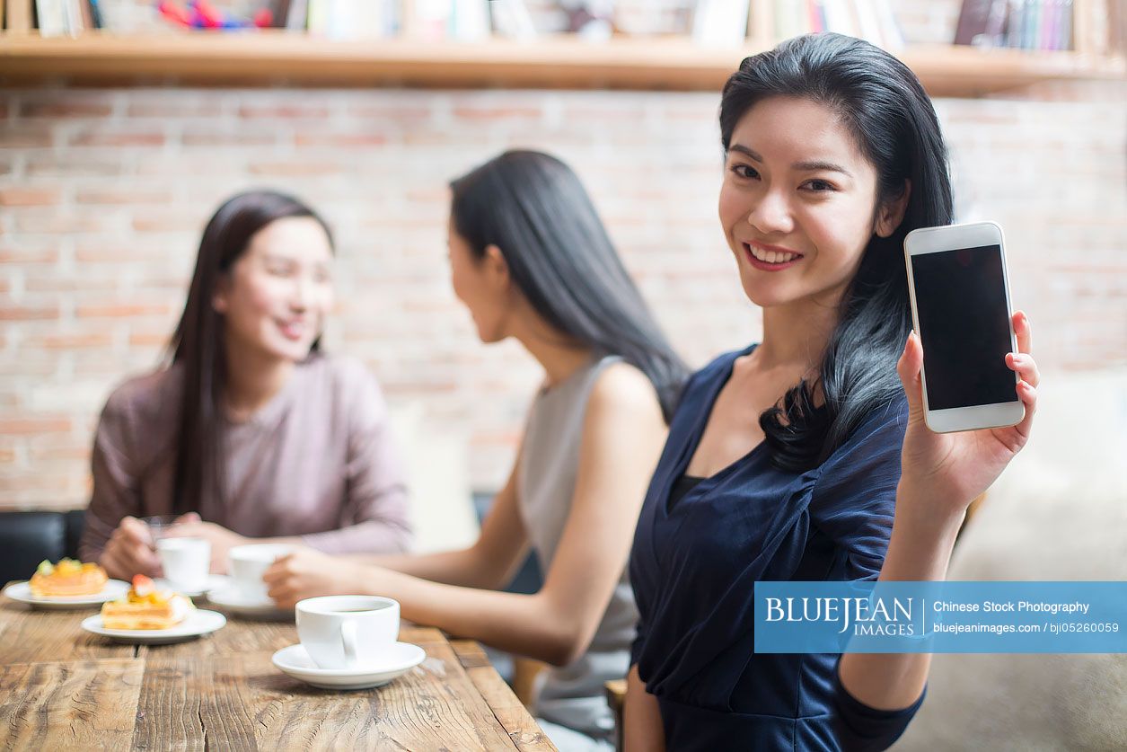 Best Chinese female friends using smart phone in café-High-res stock ...