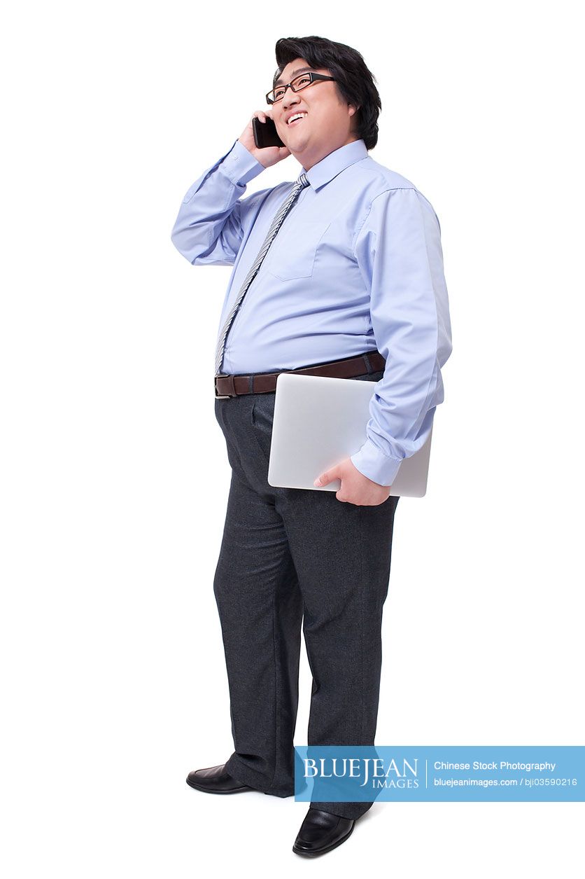 Overweight businessman talking on the phone
