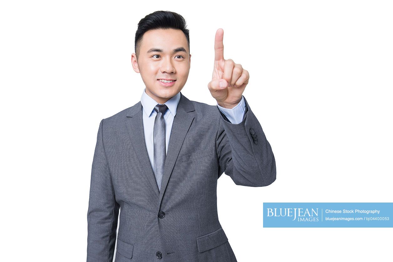 Young Chinese businessman using finger to point