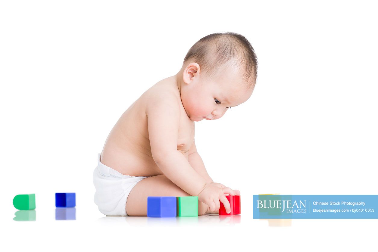 Cute Chinese baby boy playing building blocks
