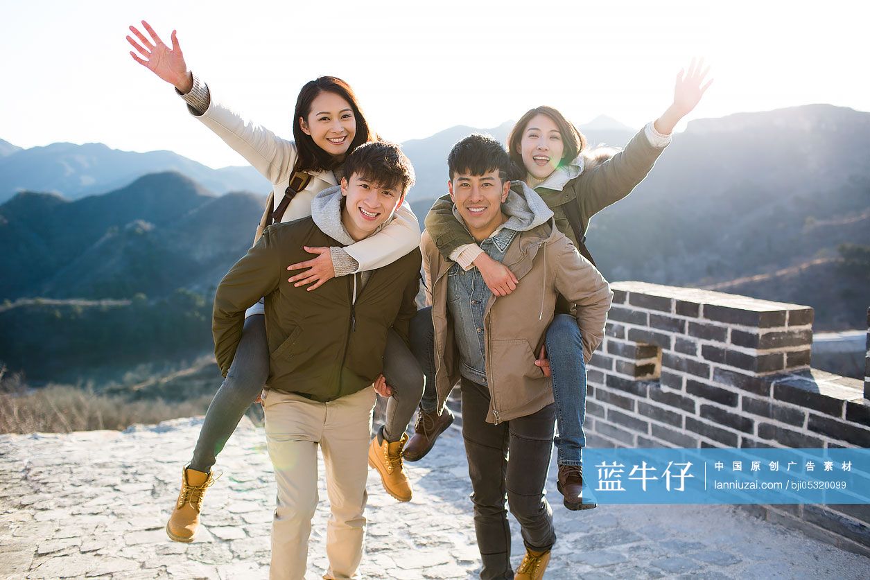 Portrait of happy young Chinese friends on the Great Wall