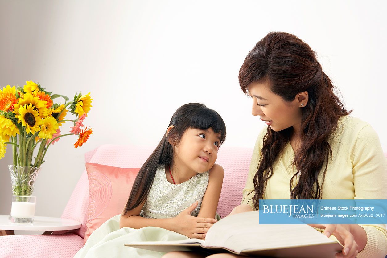 Chinese mother and daughter reading book