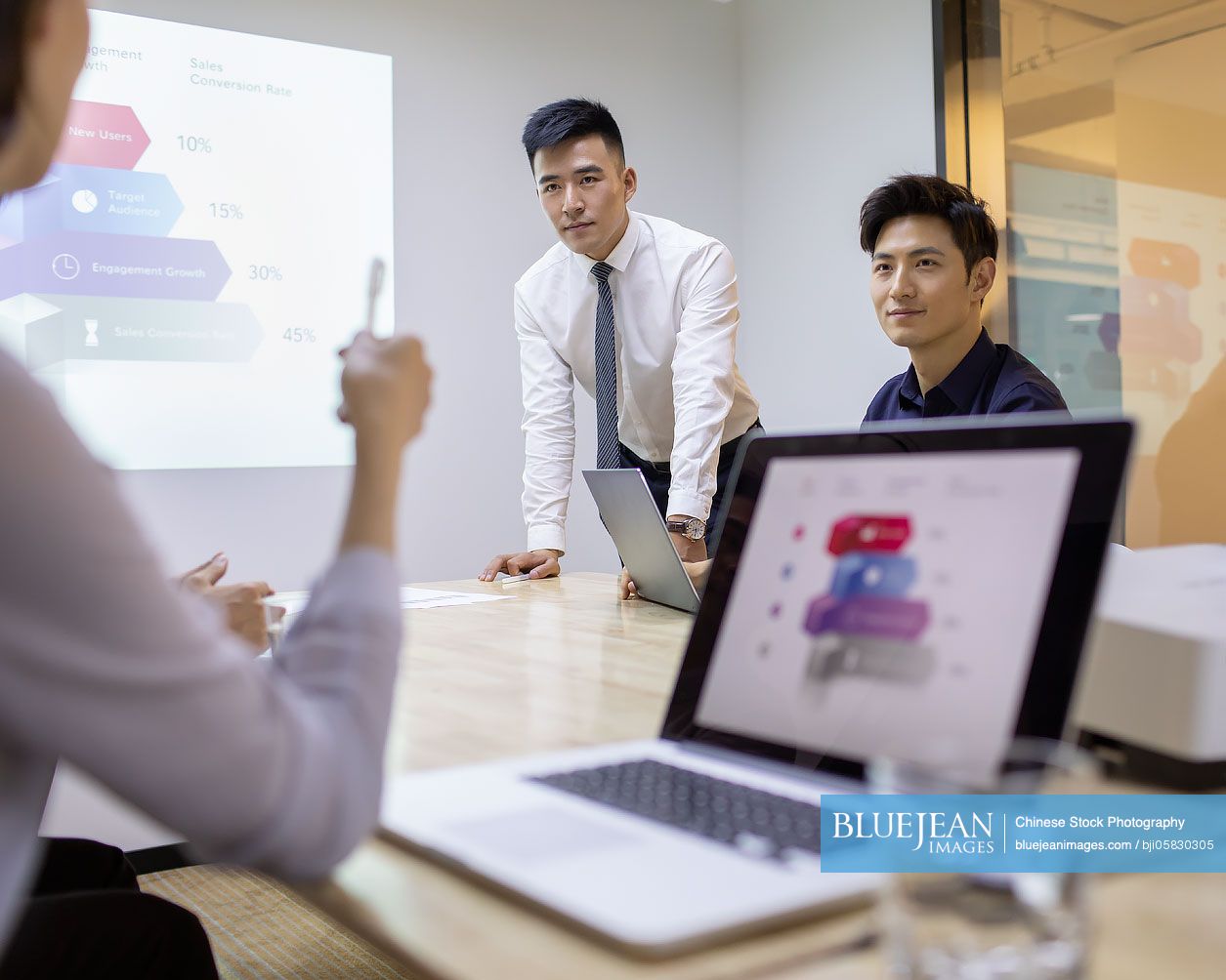 Chinese business people having meeting in board room 