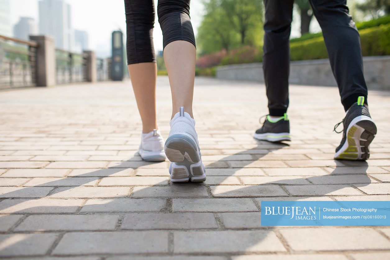 Young Chinese couple walking in park