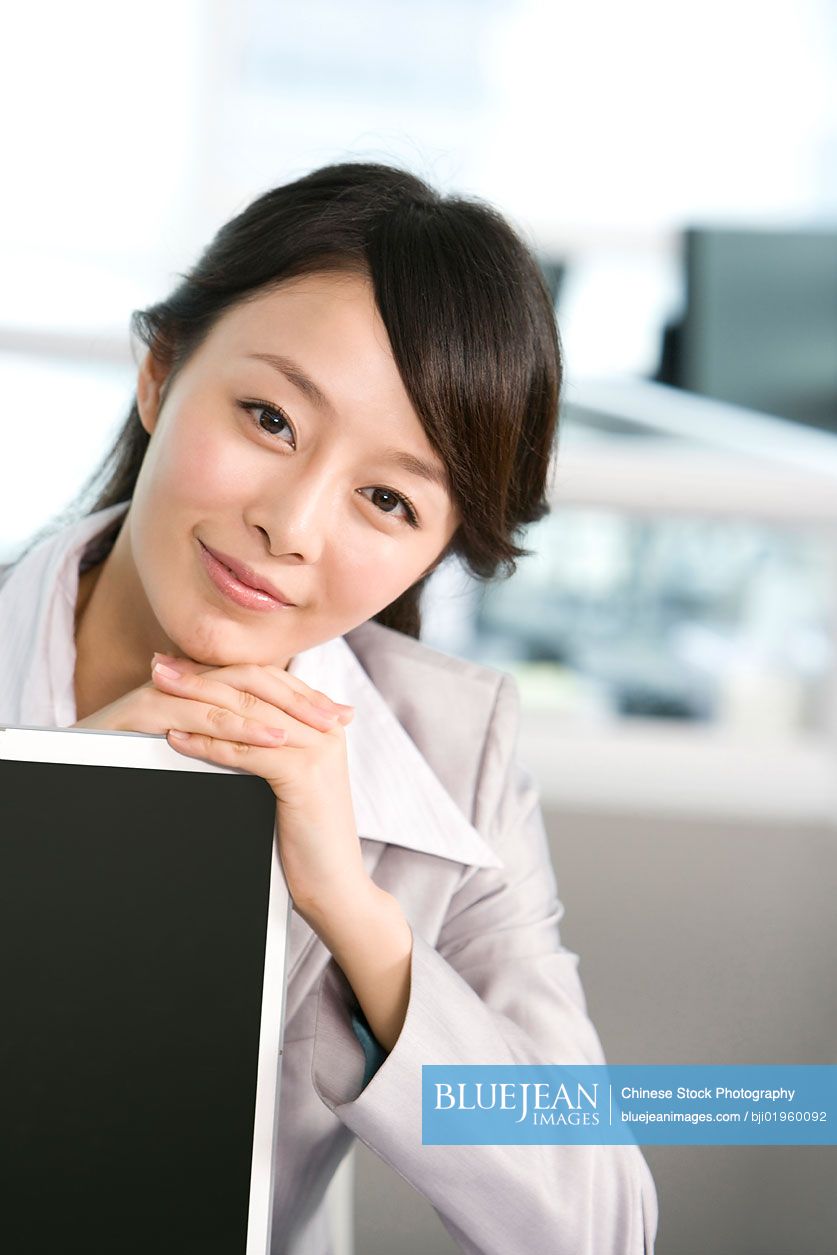 Chinese office worker at her desk