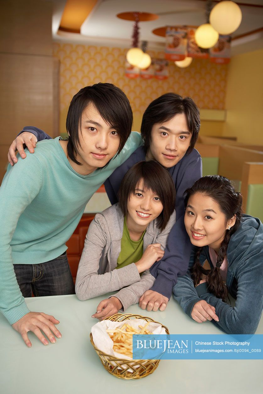 Chinese teenagers sharing French fries
