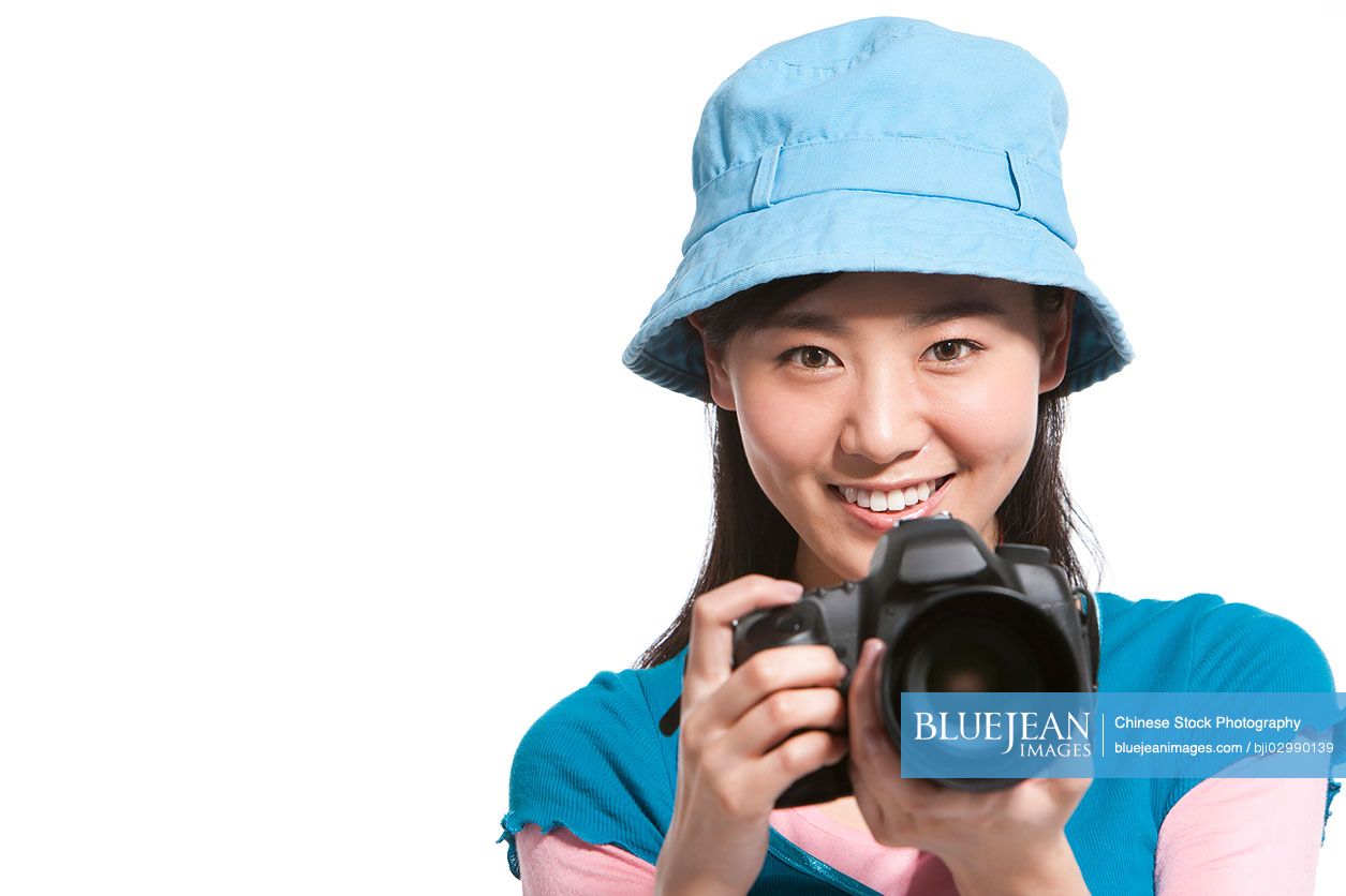 Portrait of a young Chinese woman holding a camera