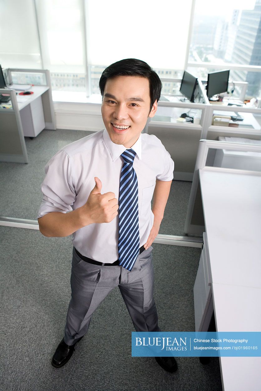 Chinese office worker giving thumbs up