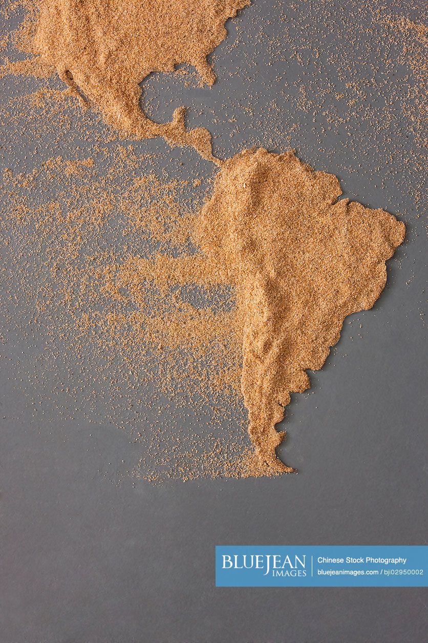 Map of Americas made of sand