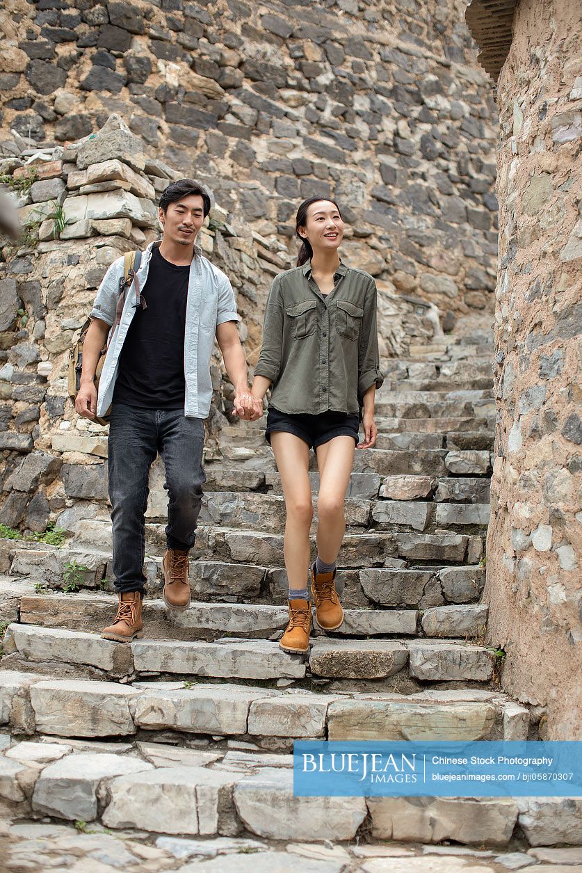Young Chinese couple hiking in village