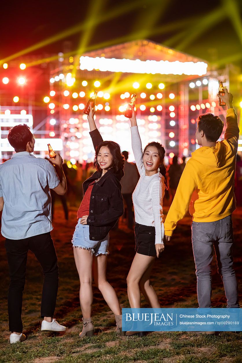 Happy young Chinese friends at music festival