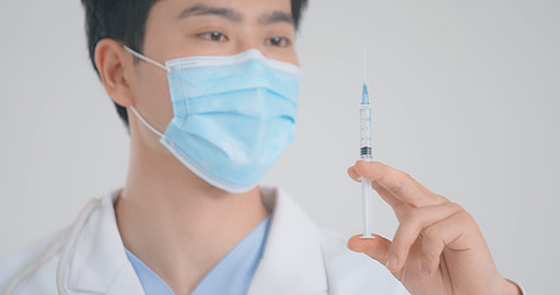 Young Chinese doctor holding syringe,4K