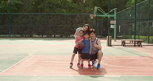 Young Chinese family playing basketball in park,4K