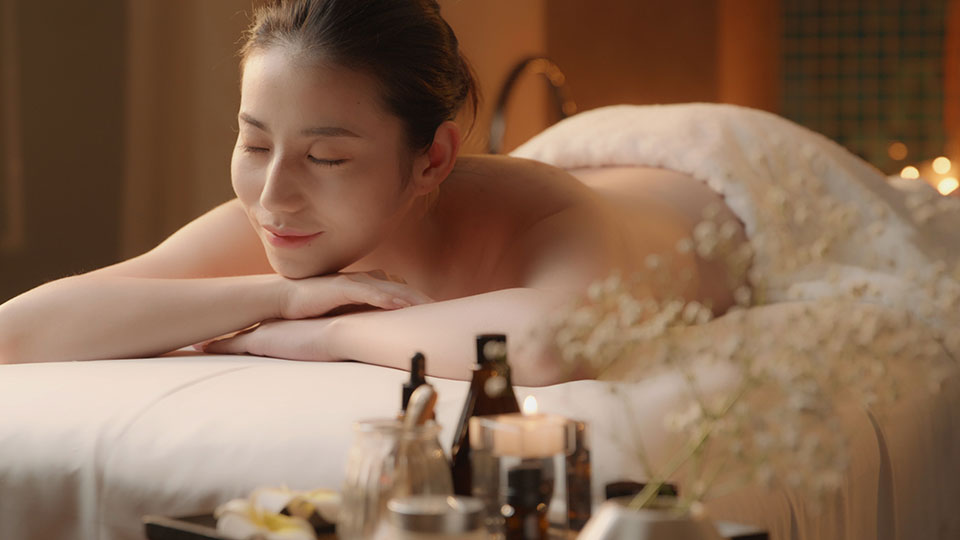 Beautiful young Chinese woman relaxing on massage table,4K-High-res stock video for download