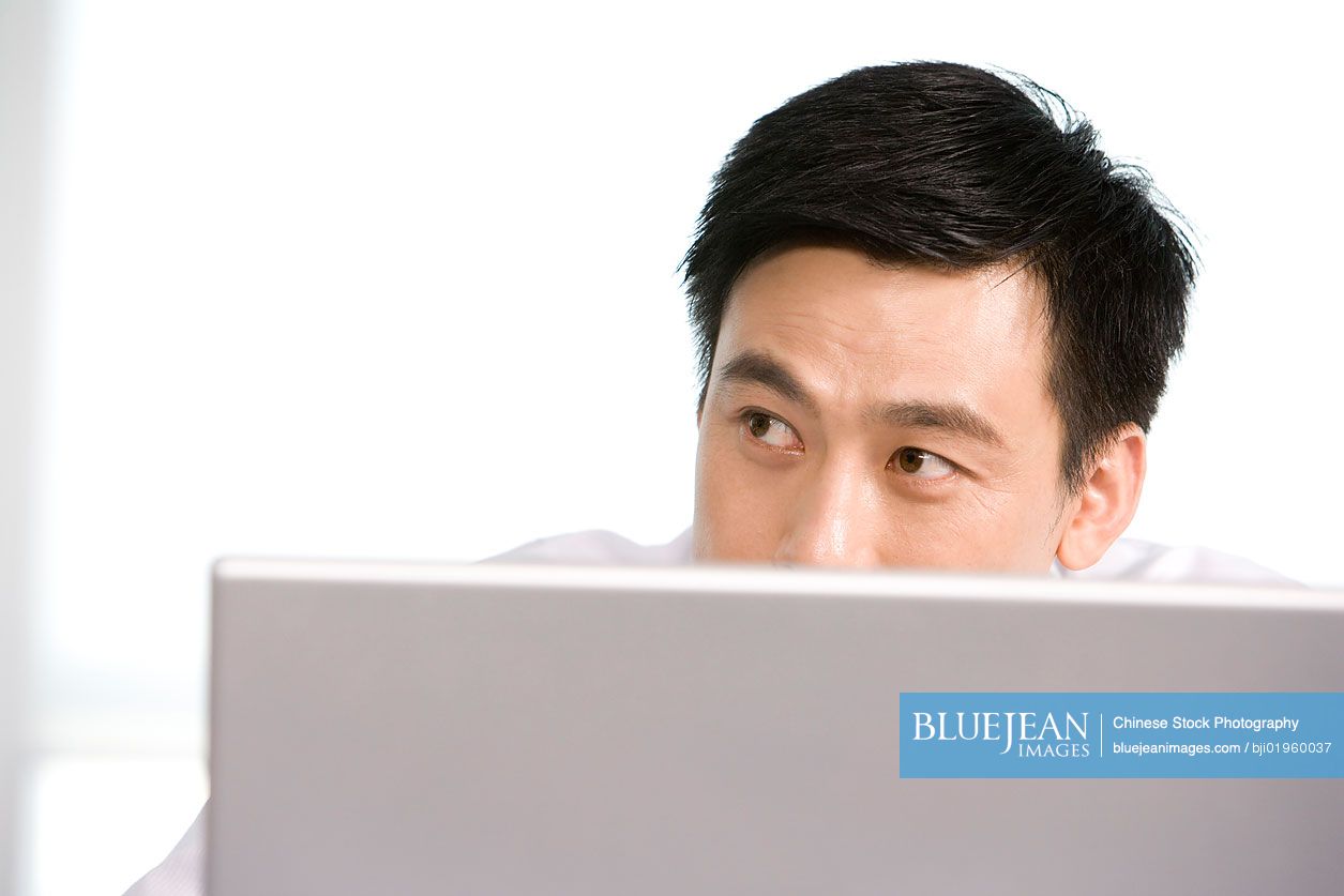 Chinese office worker at his desk