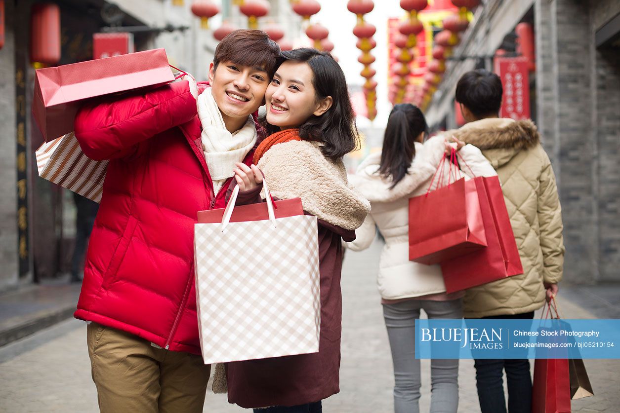 Happy young Chinese couple shopping for Chinese New Year