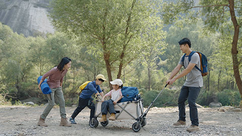 Happy young Chinese family having fun outdoors