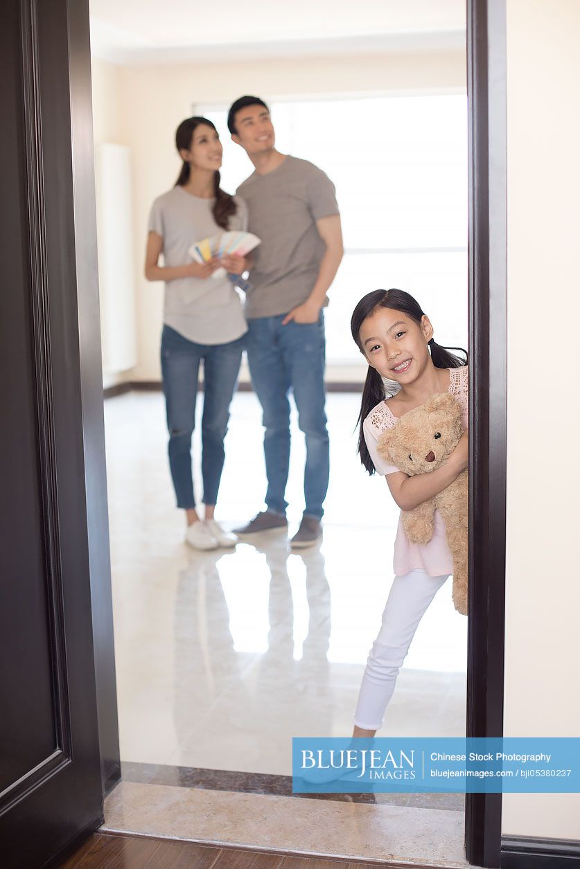 Happy young Chinese family working on home renovation