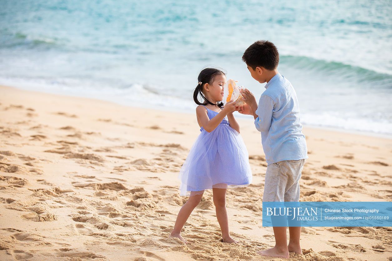 Two Chinese children on beach